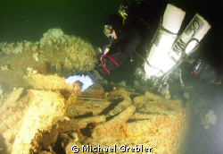 At 165 feet, a Nova Scotia tech diver examines a portion ... by Michael Grebler 